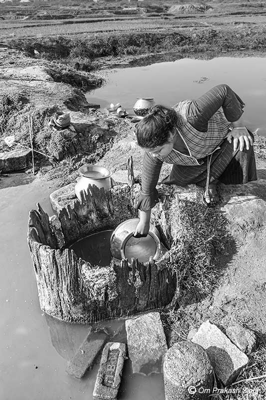 An old traditional spring-based water source with decaying wooden lining in Khunti district, Jharkhand, India